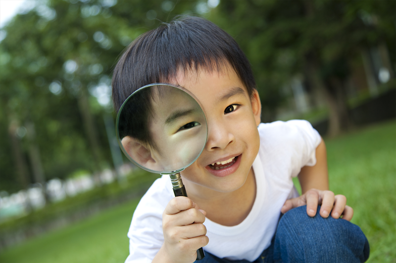 Boy with magnifying glass